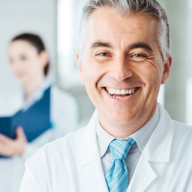 Smiling LASIK doctor with white lab coat