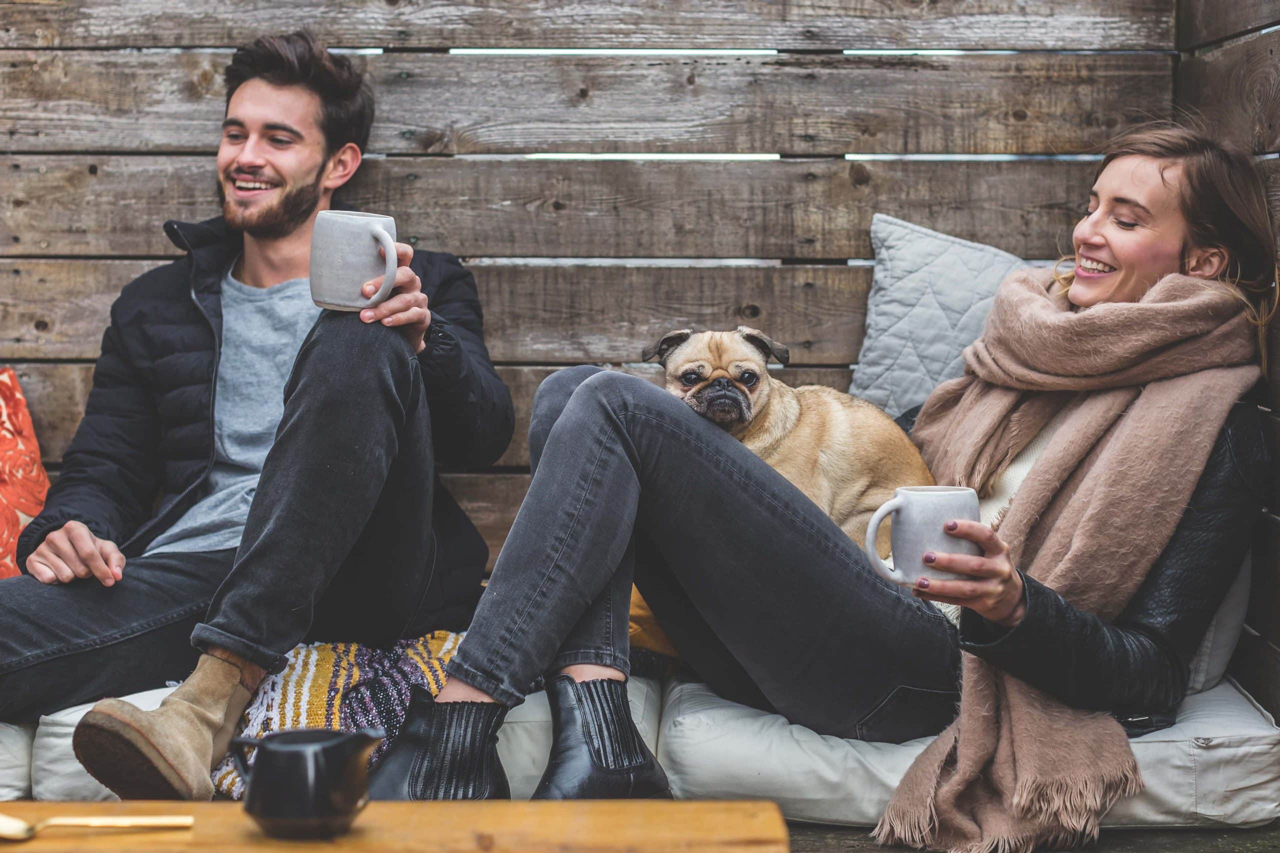 Happy people relaxing with dog